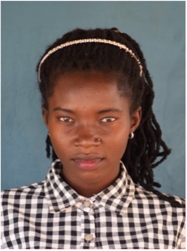 A student smiling after graduating from ECU